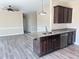 Kitchen featuring a granite-topped island, stainless steel appliances, and dark cabinets at 30 Wheat Dr, Angier, NC 27501