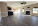 Spacious living room featuring a fireplace, modern ceiling fan, and seamless flow into the kitchen at 30 Wheat Dr, Angier, NC 27501