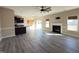 Open-concept living room with hardwood floors, fireplace, and bright natural light at 30 Wheat Dr, Angier, NC 27501