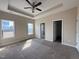 Serene main bedroom with tray ceilings, two windows, and access to an ensuite bathroom at 30 Wheat Dr, Angier, NC 27501