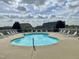 Community pool featuring numerous lounge chairs surrounding the pool, and neighborhood homes in the background at 30 Wheat Dr, Angier, NC 27501