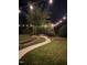 Backyard landscape featuring an outdoor patio seating area with string lights overhead at 300 Lakeside Dr, Garner, NC 27529