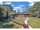 The home's backyard features a patio seating area, lush lawn, and walkway at 300 Lakeside Dr, Garner, NC 27529
