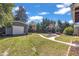 Large, grassy backyard featuring landscaping, a garage, and a patio at 300 Lakeside Dr, Garner, NC 27529