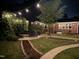 Evening backyard scene, showing a patio with seating and landscaped yard at 300 Lakeside Dr, Garner, NC 27529