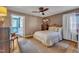 Comfortable bedroom featuring hardwood floors, a ceiling fan, and neutral walls at 300 Lakeside Dr, Garner, NC 27529