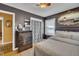 Bedroom features a dark accent wall, ceiling fan, and a mirror at 300 Lakeside Dr, Garner, NC 27529
