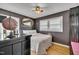 Bedroom with a globe, mirror, and ceiling fan and neutral colored walls at 300 Lakeside Dr, Garner, NC 27529