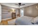 Cozy bedroom featuring warm lighting, a ceiling fan, and hardwood flooring at 300 Lakeside Dr, Garner, NC 27529