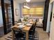 Features a long wooden table set for a meal, complemented by stylish black chairs and built-in shelving at 300 Lakeside Dr, Garner, NC 27529
