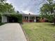 Charming one story brick home with a well-manicured lawn and unique covered carport at 300 Lakeside Dr, Garner, NC 27529