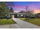 Charming single-story home boasts a well-manicured lawn and inviting brick facade, creating a warm and welcoming curb appeal at 300 Lakeside Dr, Garner, NC 27529