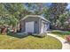 A detached garage offers extra storage space and matches the home's aesthetic at 300 Lakeside Dr, Garner, NC 27529