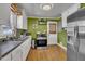 Efficient kitchen with stainless steel appliances, white cabinets, and wood flooring at 300 Lakeside Dr, Garner, NC 27529