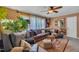 The living room offers natural light, comfortable seating, hardwood floors, and a ceiling fan at 300 Lakeside Dr, Garner, NC 27529