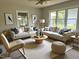 Bright living room with two sofas, large windows, neutral decor, and a stylish round coffee table at 300 Lakeside Dr, Garner, NC 27529