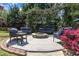 An outdoor stone fire pit is surrounded by patio furniture in the backyard at 300 Lakeside Dr, Garner, NC 27529