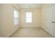 Carpeted bedroom with two windows and a door at 335 Bridgegate Dr, Cary, NC 27519