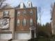 Charming brick townhouse featuring multiple windows and a two-car garage at 335 Bridgegate Dr, Cary, NC 27519