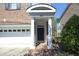 Charming brick home featuring a covered front door entrance with white columns and attached garage at 335 Bridgegate Dr, Cary, NC 27519