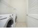 Convenient laundry room with washer, dryer, and shelving for organized storage at 335 Bridgegate Dr, Cary, NC 27519