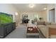 Bright living room featuring a desk, sofa, and a television for entertaining at 335 Bridgegate Dr, Cary, NC 27519