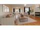 Bright living room features a fireplace, hardwood floors, and blue curtains at 335 Bridgegate Dr, Cary, NC 27519
