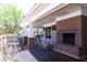 Covered porch with outdoor seating, brick fireplace, and ceiling fans at 335 Bridgegate Dr, Cary, NC 27519
