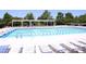 Outdoor lap pool with ladder and lounge chairs for enjoyment at 335 Bridgegate Dr, Cary, NC 27519
