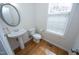 Powder room featuring hardwood floors, modern fixtures and bright natural light at 335 Bridgegate Dr, Cary, NC 27519
