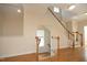 Staircase with wood railing and trim with natural light, connecting floors at 335 Bridgegate Dr, Cary, NC 27519