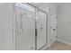 Walk-in shower with glass enclosure, tiled walls, and modern fixtures at 3409 Lily Orchard Way, Apex, NC 27539