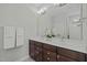 Bathroom featuring a dual sink vanity, large mirror and modern fixtures at 3409 Lily Orchard Way, Apex, NC 27539