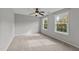 A bright, carpeted bedroom with two windows and a ceiling fan at 3409 Lily Orchard Way, Apex, NC 27539