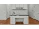 Desk area featuring ample cabinetry, drawers and decorative staging for a stylish aesthetic at 3409 Lily Orchard Way, Apex, NC 27539