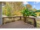 A wooden deck overlooks a beautiful backyard with lush banana trees at 3409 Lily Orchard Way, Apex, NC 27539