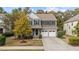 Charming two-story home with a stone facade, a well-maintained lawn, and a two-car garage at 3409 Lily Orchard Way, Apex, NC 27539