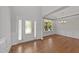 Elegant foyer with hardwood floors, tray ceiling, and ample natural light from the front door and windows at 3409 Lily Orchard Way, Apex, NC 27539