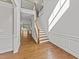 Welcoming foyer with hardwood floors, staircase, and access to the living area at 3409 Lily Orchard Way, Apex, NC 27539