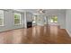 Bright living room with hardwood floors, a fireplace and large windows at 3409 Lily Orchard Way, Apex, NC 27539