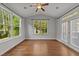 Sun room with hardwood flooring, backyard views, and natural light at 3409 Lily Orchard Way, Apex, NC 27539
