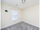 Bright bedroom with gray carpet, window, and neutral walls at 4011 Volkswalk Pl, Raleigh, NC 27610