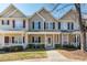 Inviting townhome with covered porch and well-maintained landscaping, creating a welcoming entrance at 4011 Volkswalk Pl, Raleigh, NC 27610