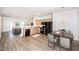Open-concept kitchen with a breakfast bar, black appliances, and light wood cabinets at 4011 Volkswalk Pl, Raleigh, NC 27610