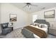 Well-lit main bedroom boasts a decorative ceiling fan, neutral colors, and comfortable furnishings at 4011 Volkswalk Pl, Raleigh, NC 27610
