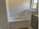 Clean white bathtub with subway tile surround and a modern faucet at 4013 Kingcraig Ln, Zebulon, NC 27597