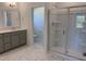Bathroom featuring a large shower, grey cabinets, and a grey and white marble floor at 4013 Kingcraig Ln, Zebulon, NC 27597