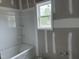Bathroom with window and white tub at 4013 Kingcraig Ln, Zebulon, NC 27597