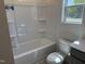A well-lit bathroom features a white tub and shower combo, plus a window at 4013 Kingcraig Ln, Zebulon, NC 27597