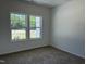 Bedroom featuring carpet, natural light from two windows, and neutral paint at 4013 Kingcraig Ln, Zebulon, NC 27597